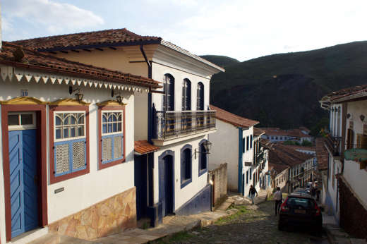 Charming cobbled street with colourful colonial houses in Ouro Preto, Minas Gerais, Brazil. 