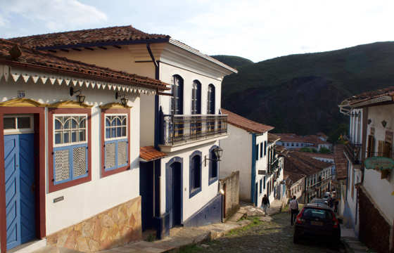 Colonial cobbled street with colourful colonial houses in Ouro Preto, Minas Gerais, Brazil. 