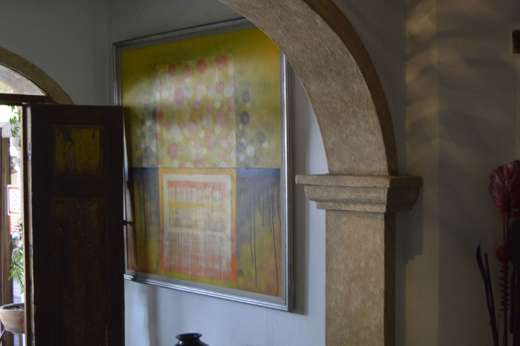 Rustic stone archway with wooden door, jar, and patterned lighting inside a boutique hotel in San Miguel de Allende, Mexico. 