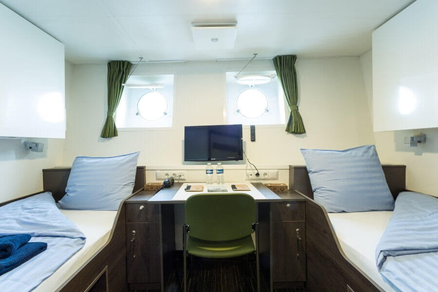 A twin bed porthole cabin