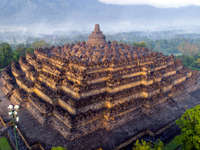 Borobudur Temple rises from the mist in Magelang, Central Java, Indonesia. 