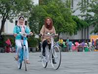 Women enjoying cycling in Jakarta's Old Town, promoting inclusive tourism experience in Indonesia's capital. 