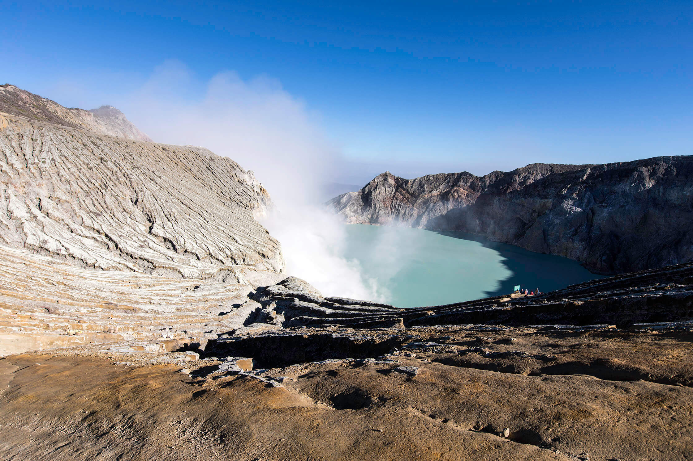 Volcanic crater of Kawah Ijen in East Java, Indonesia, with turquoise acidic lake and rising sulphuric smoke. 