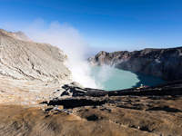 Volcanic crater of Kawah Ijen in East Java, Indonesia, with turquoise acidic lake and rising sulphuric smoke. 