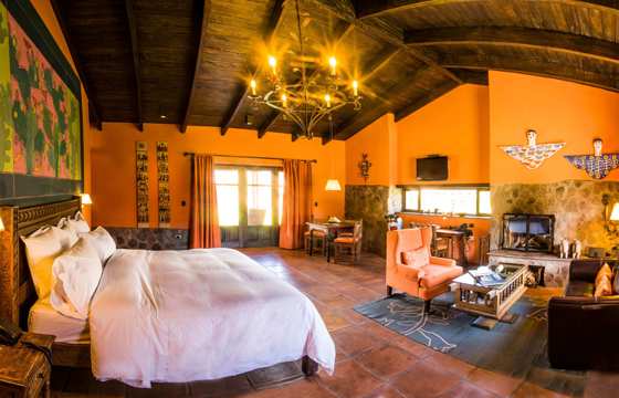 Warm Andean decor and rustic elegance define this cozy suite at Sol y Luna in the Sacred Valley. 