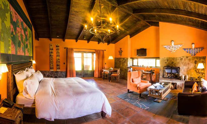 Warm Andean decor and rustic elegance define this cozy suite at Sol y Luna in the Sacred Valley. 