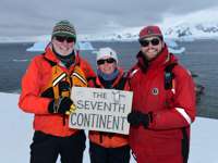 Expedition guests celebrate reaching Antarctica, the world's seventh continent. 