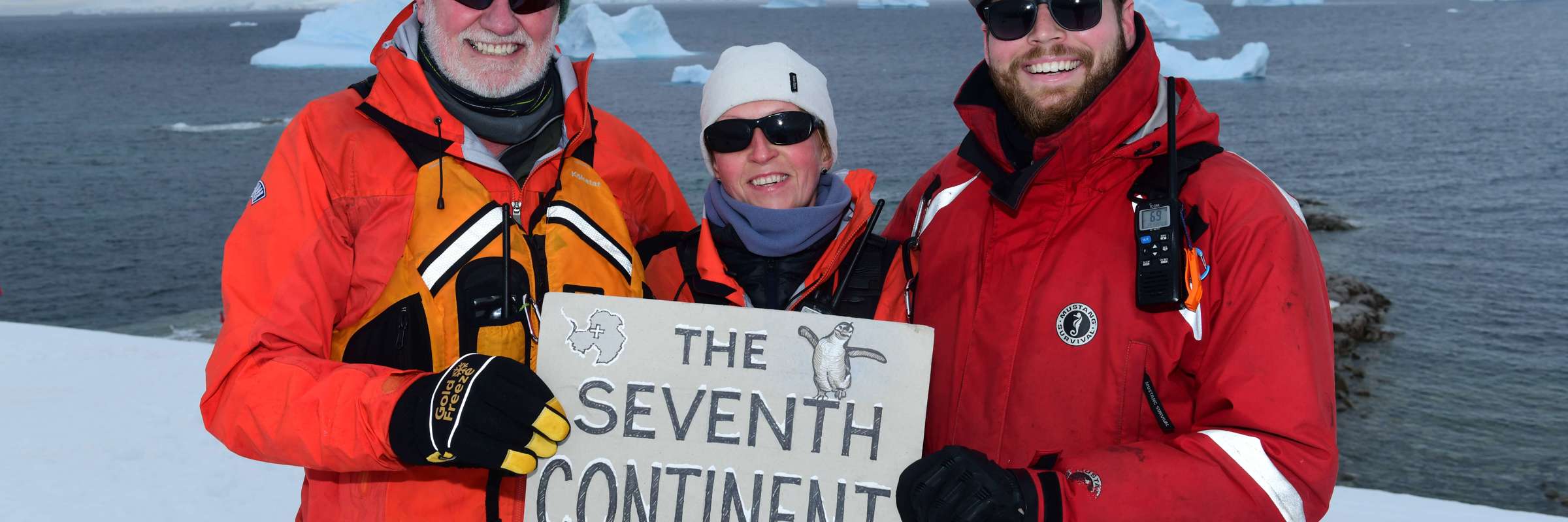 Expedition guests celebrate reaching Antarctica, the world's seventh continent. 