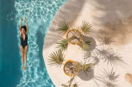 Overhead view of the swimming pool at Casa Sandra on Holbox Island, with tropical plants and a guest swimming below. 