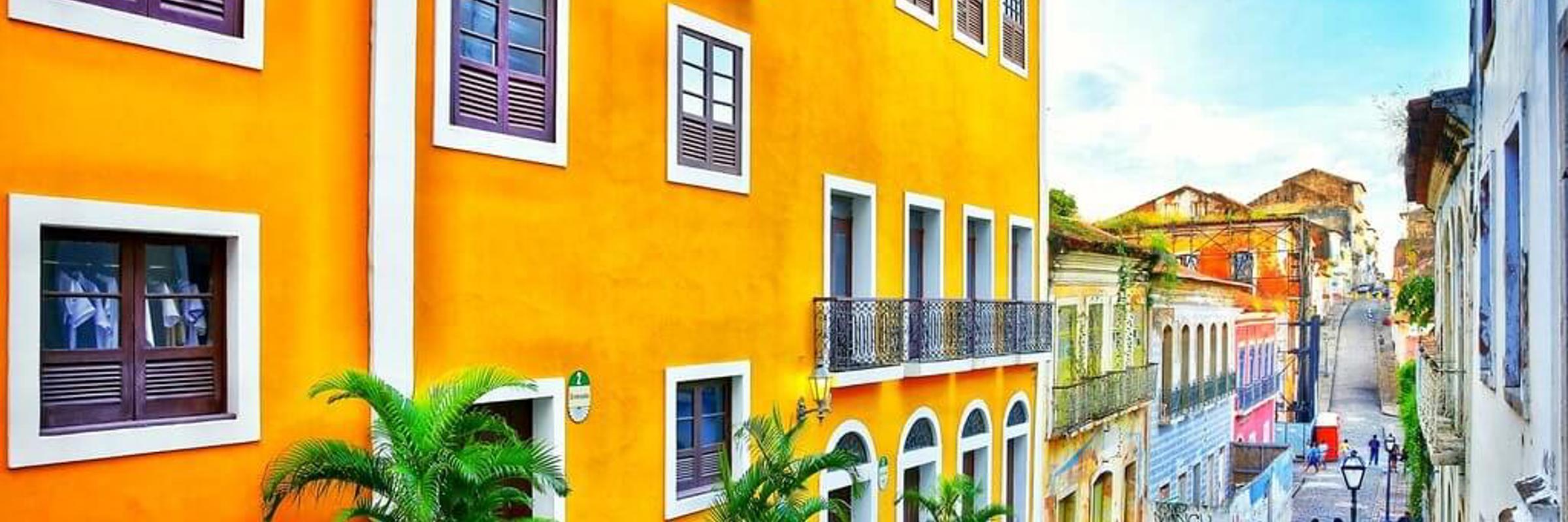 Colourful colonial buildings on a cobbled street in Sao Luis, Maranhao, Brazil, with people walking in the historic centre.