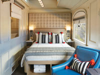 Junior double cabin aboard the Belmond Andean Explorer with scenic window views. 