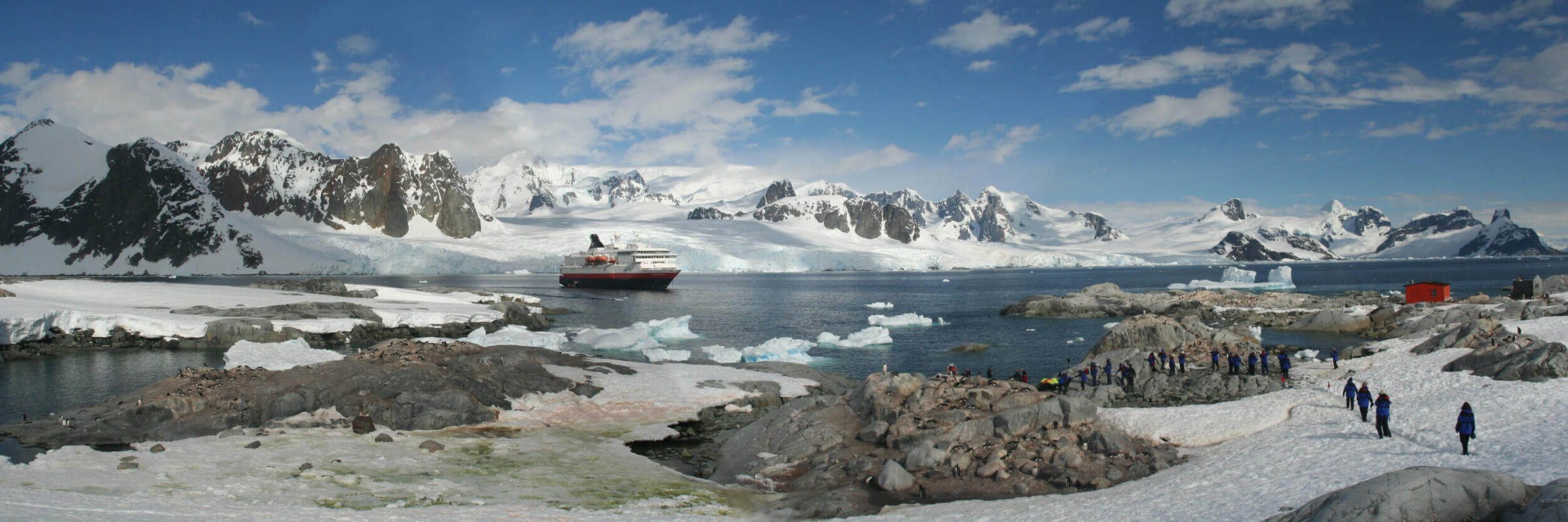 Expedition cruise lands in Antarctica amid glaciers, mountains, and wildlife. 