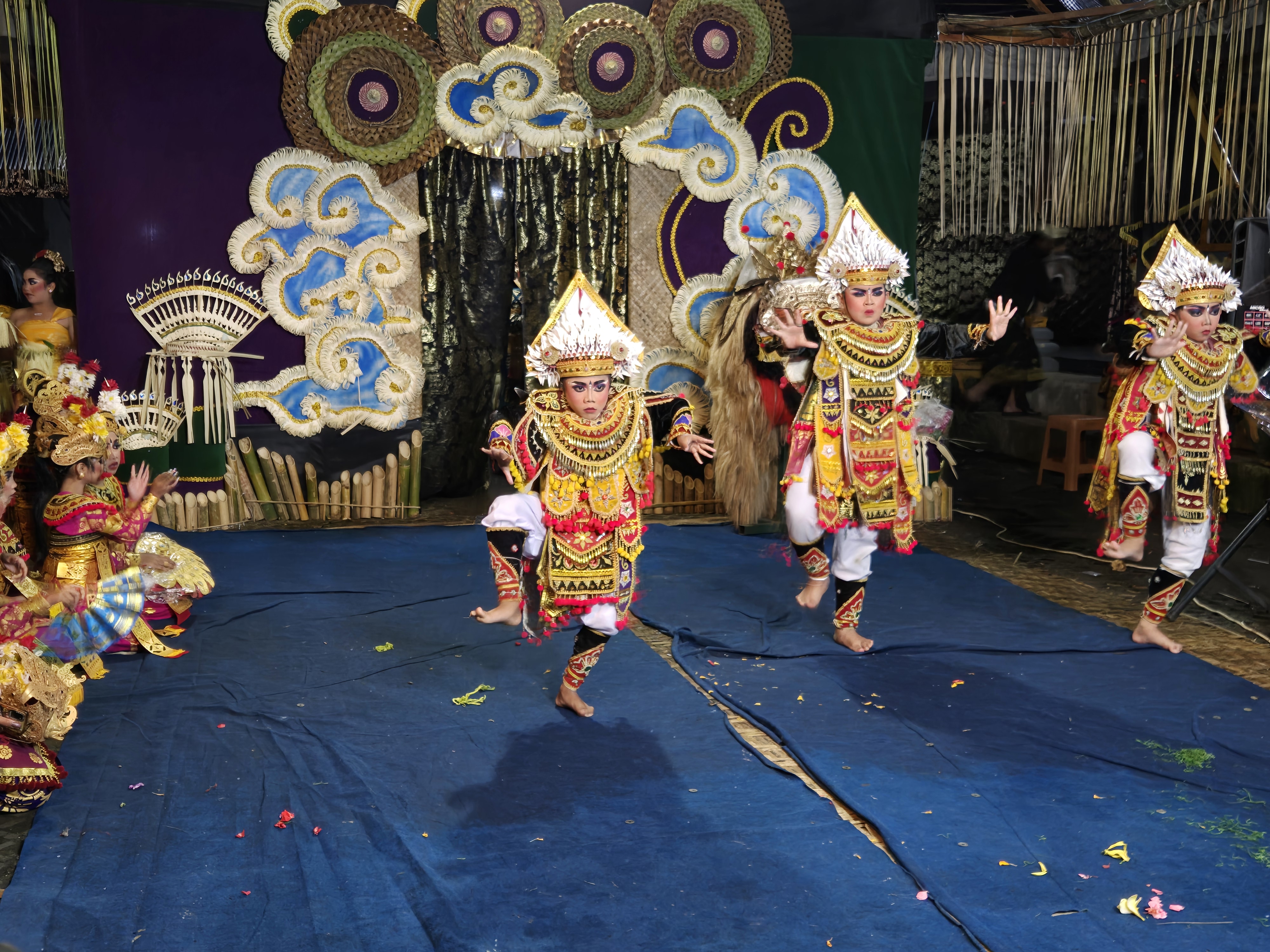 Children in elaborate costumes perform a traditional Balinese dance on a festive stage in Bali, Indonesia. 