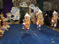 Children in elaborate costumes perform a traditional Balinese dance on a festive stage in Bali, Indonesia. 