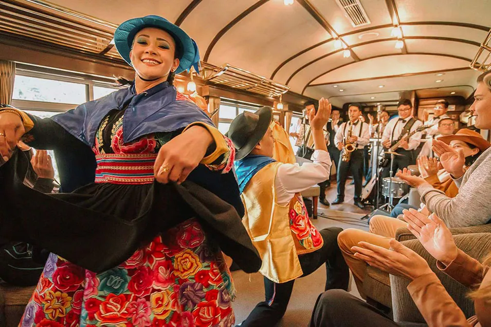 Traditional dancers and live band performing on board the Belmond Hiram Bingham train to Machu Picchu. 