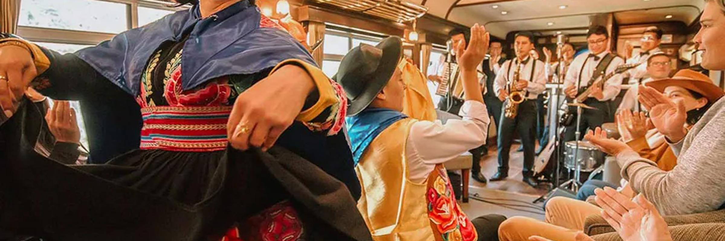 Traditional dancers and live band performing on board the Belmond Hiram Bingham train to Machu Picchu. 