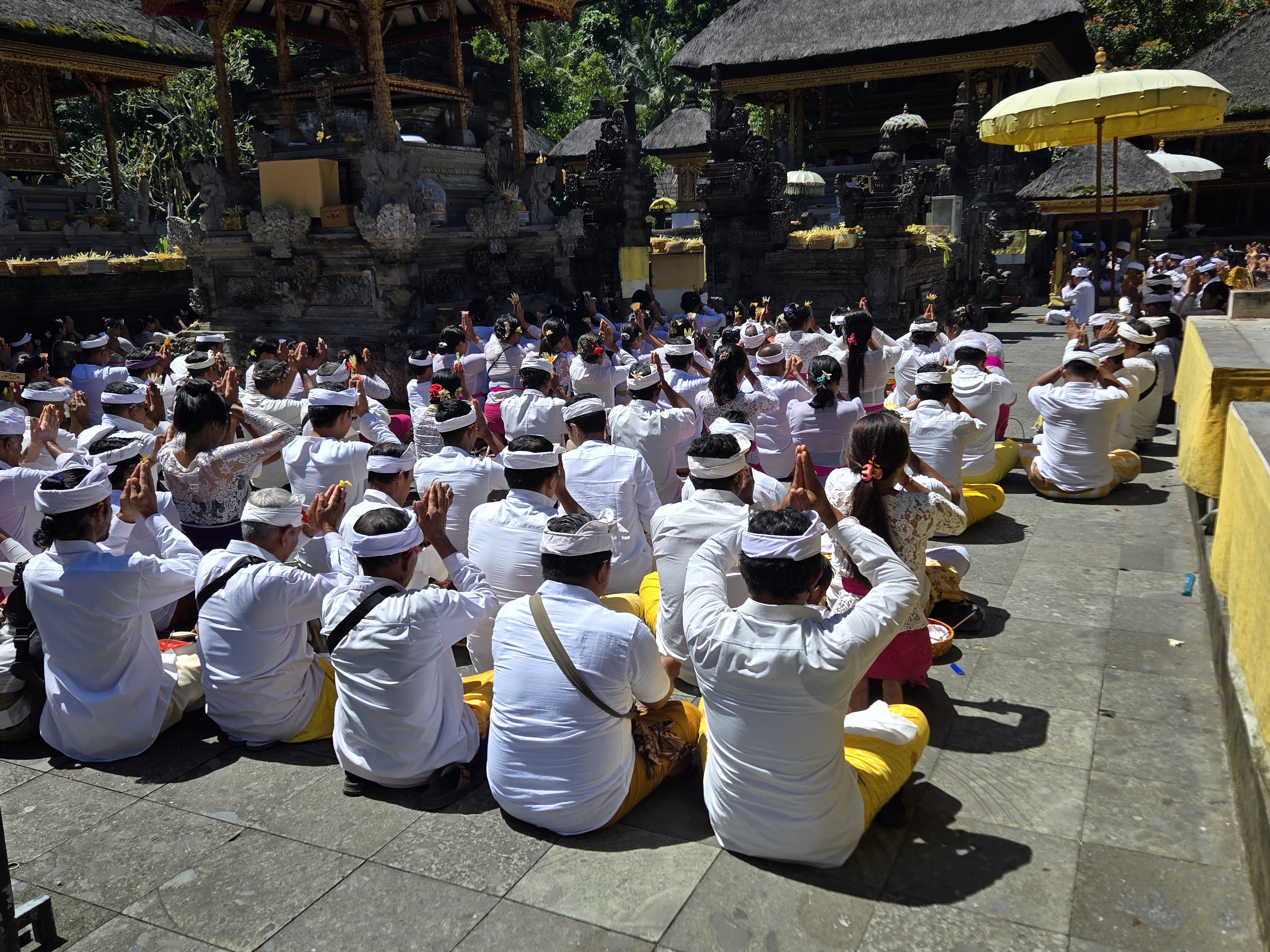 Balinese worshippers dressed in white gather in prayer during a temple ceremony in Bali, Indonesia. 
