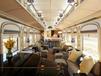 Elegant bar car on the Belmond Andean Explorer, with lounge seating and large scenic windows. 