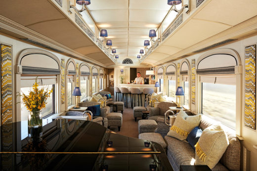 Elegant bar car on the Belmond Andean Explorer, with lounge seating and large scenic windows. 