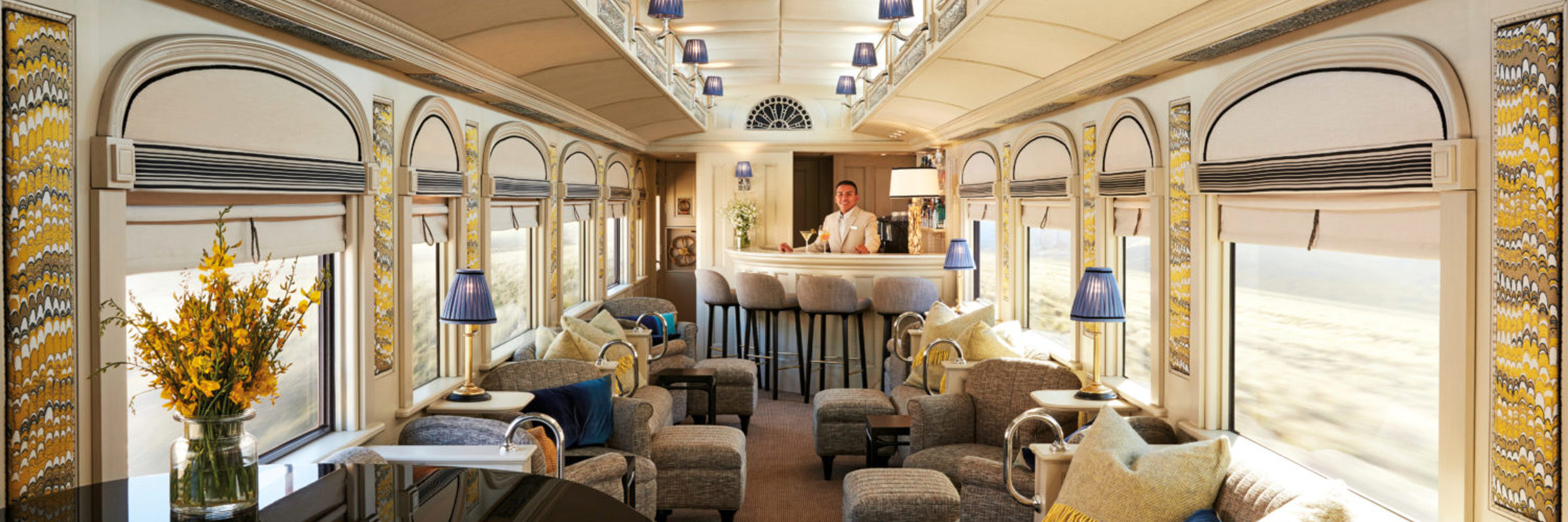 Elegant bar car on the Belmond Andean Explorer, with lounge seating and large scenic windows. 