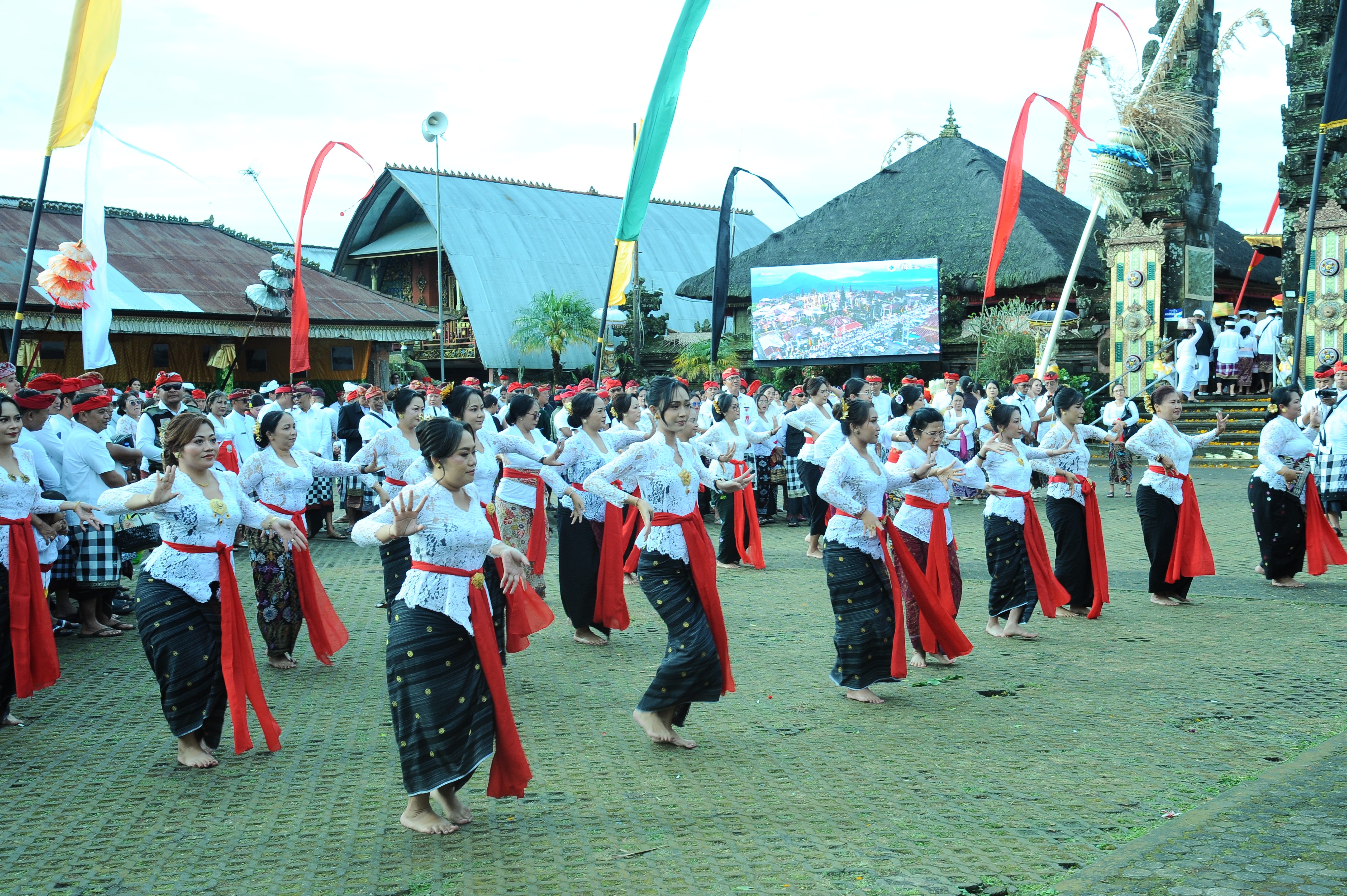 Balinese women in traditional dress perform a synchronized group dance at the Galungan festival in Bali, Indonesia. 