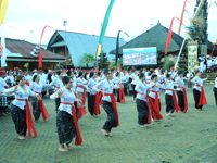 Balinese women in traditional dress perform a synchronized group dance at the Galungan festival in Bali, Indonesia. 