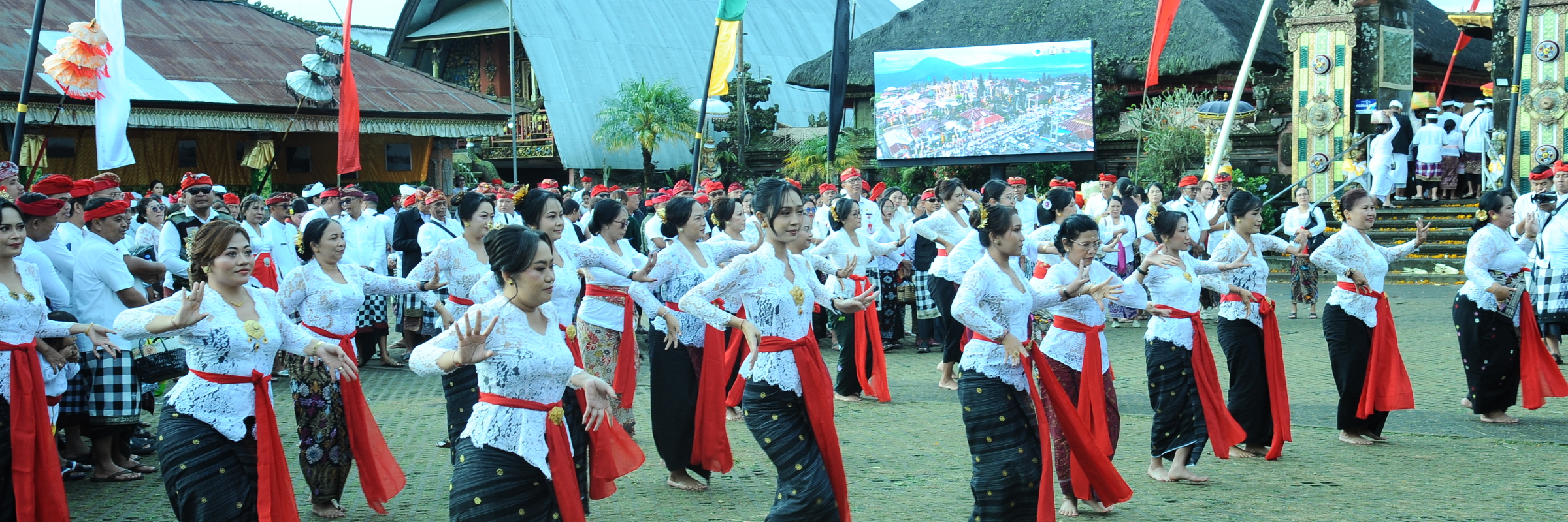 Balinese women in traditional dress perform a synchronized group dance at the Galungan festival in Bali, Indonesia. 